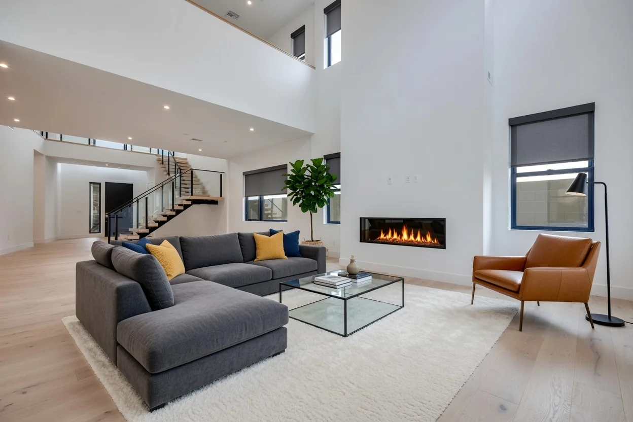 Charcoal roller shades in an airy contemporary great room